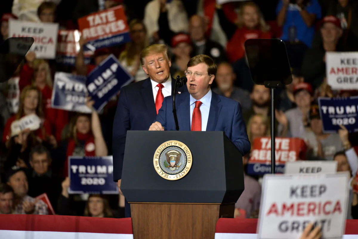 Then-Mississippi Republican gubernatorial candidate Tate Reeves (R) speaks alongside then-President Donald Trump during a "Keep America Great" campaign rally at BancorpSouth Arena in Tupelo, Mississippi, on Nov. 1, 2019. (Brandon Dill/Getty Images)