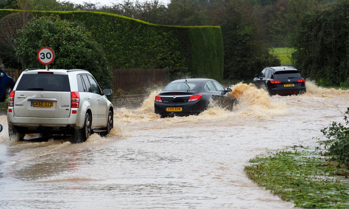 Vehicles drive through a flooded road in Yapton, West Sussex, as Storm Ciaran brings high winds and heavy rain along the south coast of England on Nov. 2, 2023.
(Joe Sene/PA Wire)