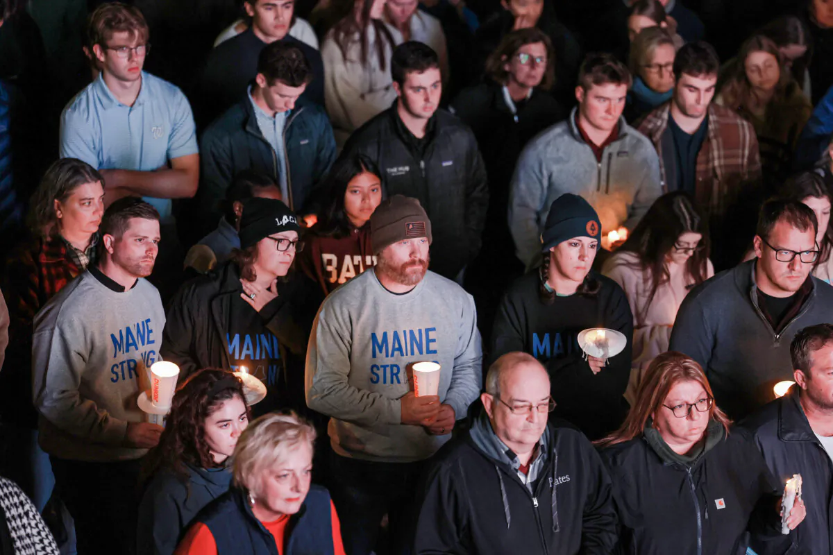 An overflow crowd watches a television screen as it broadcasts from inside the Basilica of Saints Peter and Paul the remembrance ceremony in Lewiston, Maine, on Oct. 29, 2023. (Joe Raedle/Getty Images)