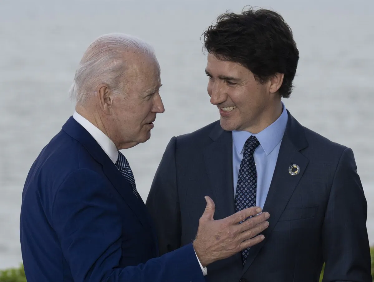 Prime Minister Justin Trudeau talks with United States President Joe Biden during a family photo with G7 leaders and outreach countries and international organizations in Hiroshima, Japan on May 20, 2023. (The Canadian Press/Adrian Wyld)