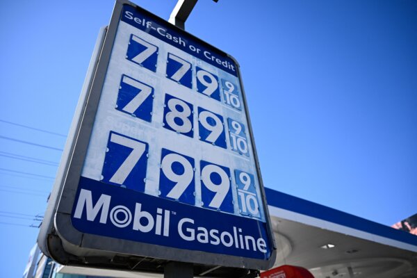 A sign shows gasoline fuel prices above average