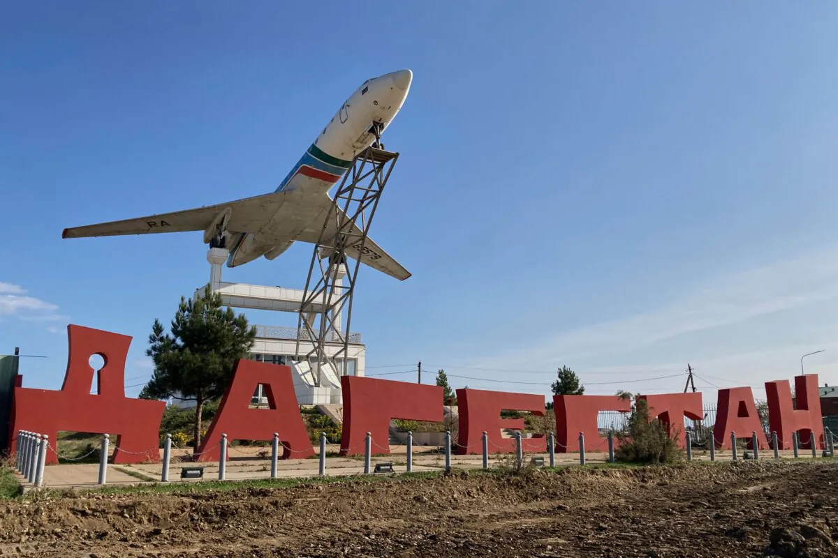 A Tupolev Tu-134B passenger plane is seen on a base next to a sign reading “Dagestan” outside the airport in Makhachkala on Oct. 30, 2023. Russian police on Oct. 30, 2023, said they had arrested 60 people suspected of storming an airport in the Muslim-majority Caucasus republic of Dagestan, seeking to attack Jewish passengers coming from Israel. (STR/AFP via Getty Images)