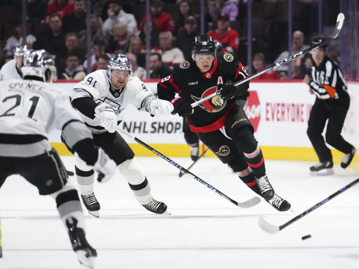 Ottawa Senators center Tim Stutzle (18) races against Los Angeles Kings right wing Carl Grundstrom (91) for the puck during the first period of an NHL hockey game in Ottawa, Ontario, on Nov. 2, 2023. (Sean Kilpatrick/The Canadian Press via AP)