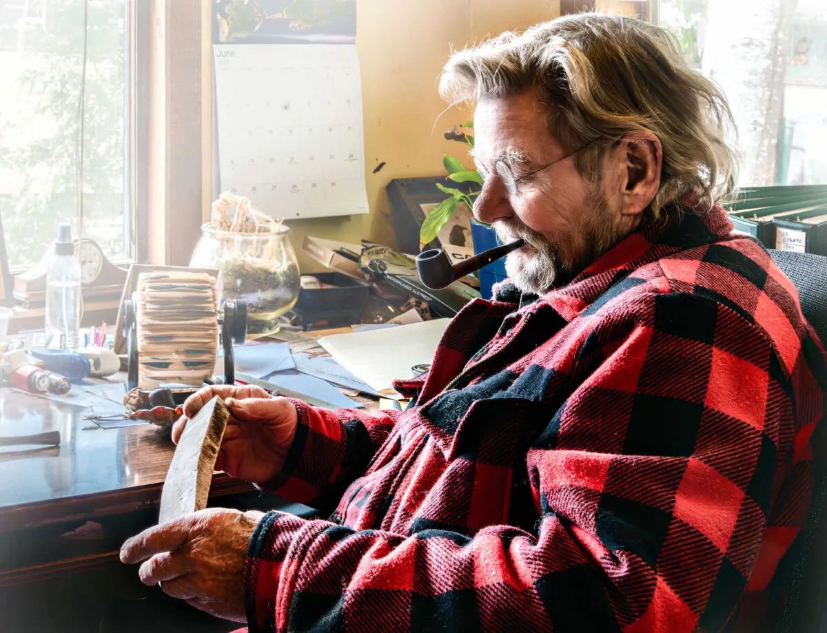 Eric Hollenbeck inspects a piece of wood in the Blue Ox Millworks office in Eureka, Calif. (Maria Coulson)
