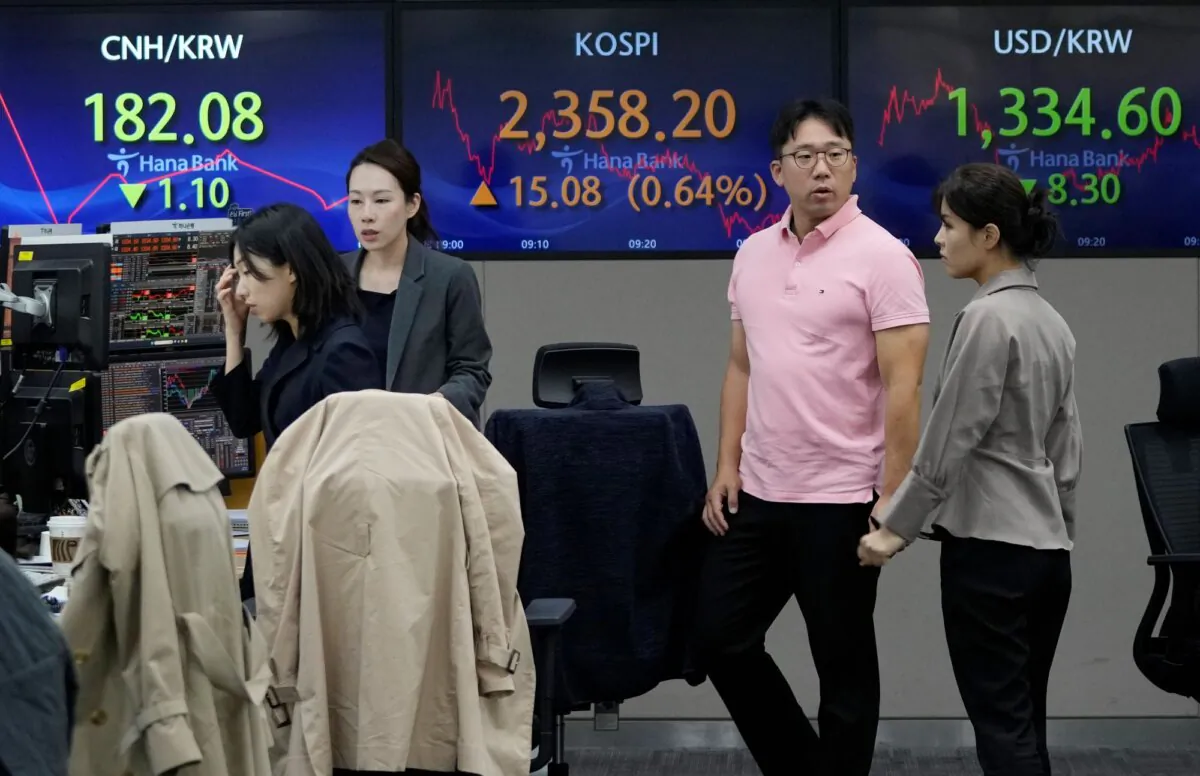Currency traders work near the screens showing the Korea Composite Stock Price Index (KOSPI), (C), and the foreign exchange rate between U.S. dollar and South Korean won, (R), at the foreign exchange dealing room of the KEB Hana Bank headquarters in Seoul, South Korea, on Nov. 3, 2023. (Ahn Young-joon/AP)