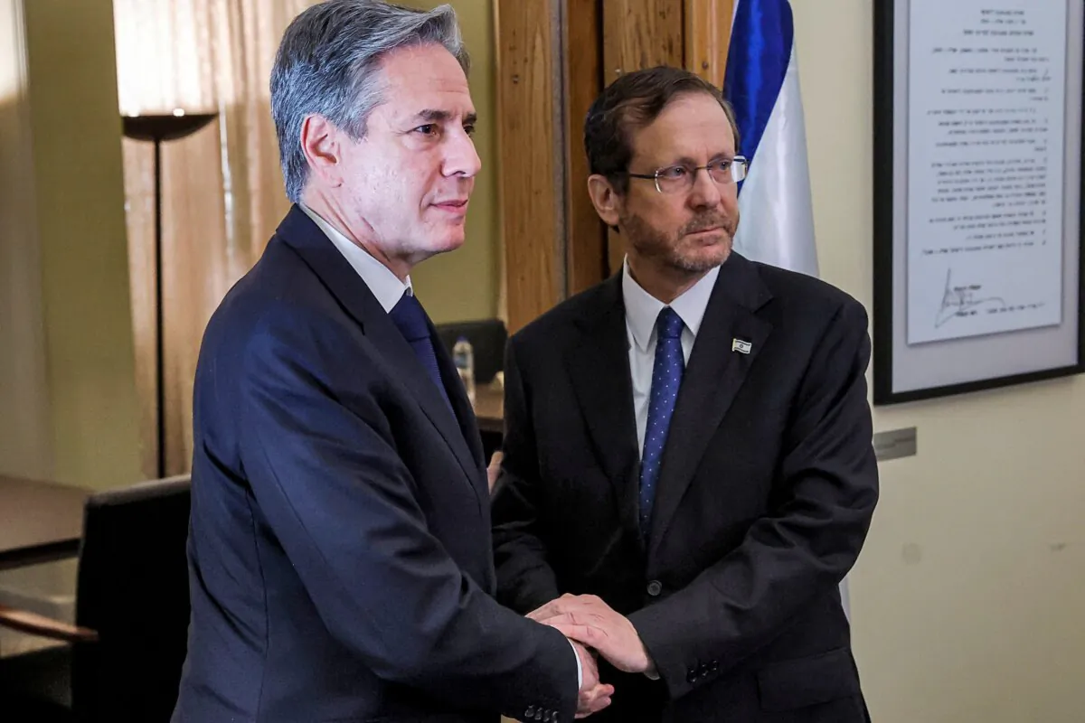 U.S. Secretary of State Antony Blinken (L) shakes hands with Israeli President Isaac Herzog during their meeting at the Ben-Gurion House on the Kirya military base in Tel Aviv, Israel, on Nov. 3, 2023. (Jonathan Ernst/Pool/AFP via Getty Images)