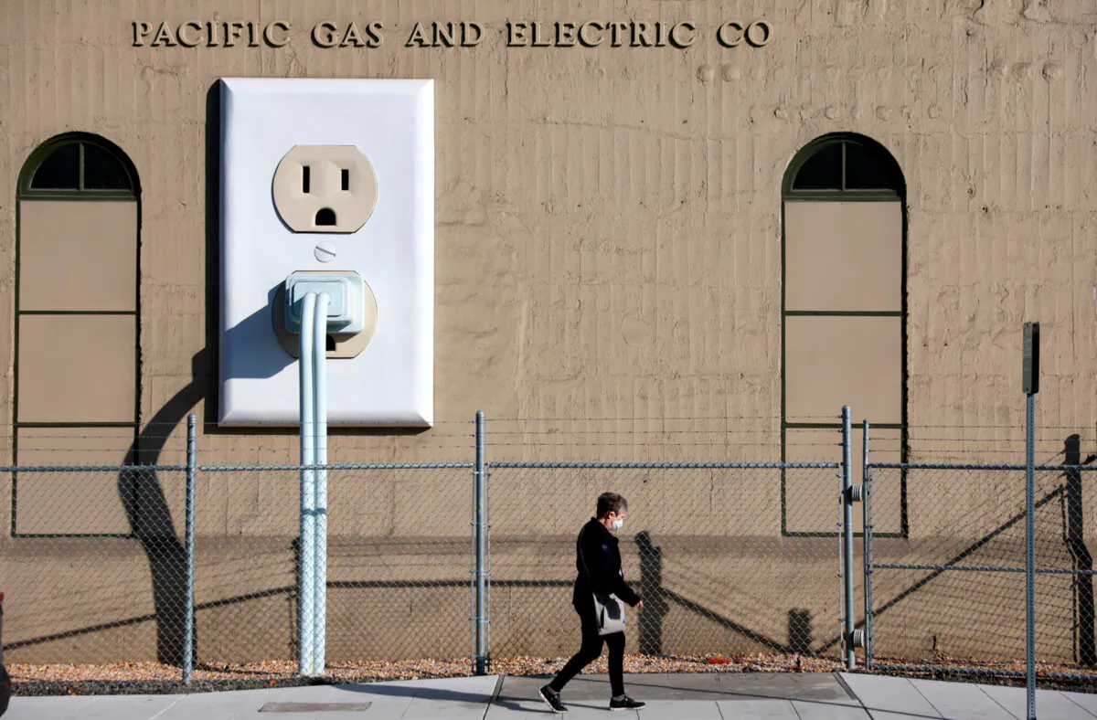 A pedestrian walks by a Pacific Gas & Electric (PG&E) electrical substation in Petaluma, California, on January 26, 2022. (Justin Sullivan/Getty Images)