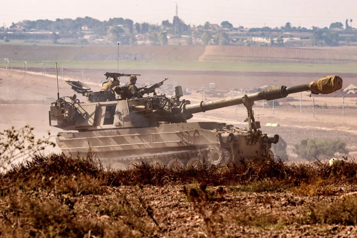 An Israeli army artillery howitzer moves at a position near the border with the Gaza Strip in southern Israel, on Nov. 3, 2023. (Jack Guez/AFP via Getty Images)