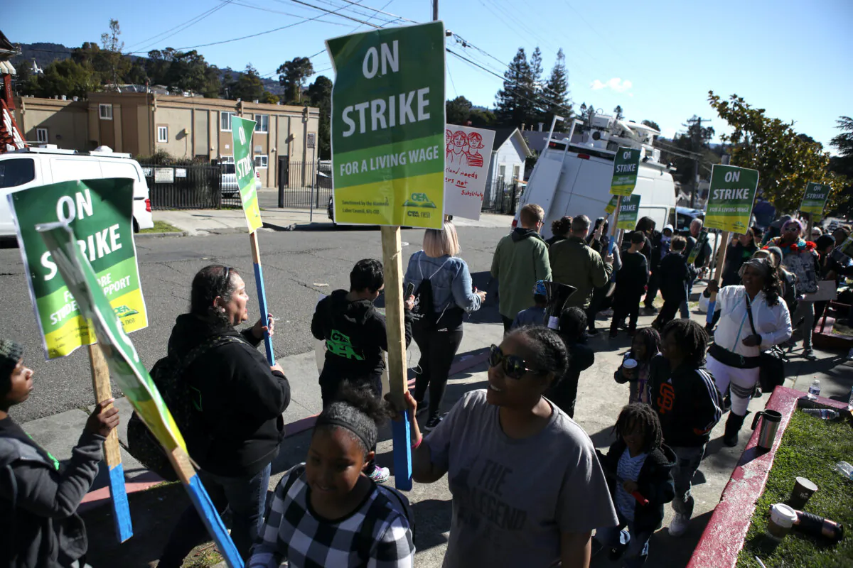 Oakland Unified School District students, teachers and parents carry signs as they picket outside of Manzanita Community School in a file photo in Oakland, Calif., on Feb. 21, 2019. (Justin Sullivan/Getty Images)