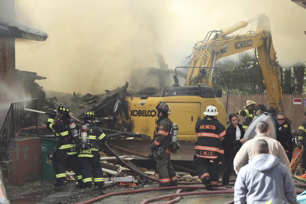 Firefighters work to extinguish fires inside the homes on Brick Row, in the Village of Wappingers Falls, N.Y., on Nov. 2, 2023, after a gas main was ruptured. (Patrick Oehler/The Journal via AP)