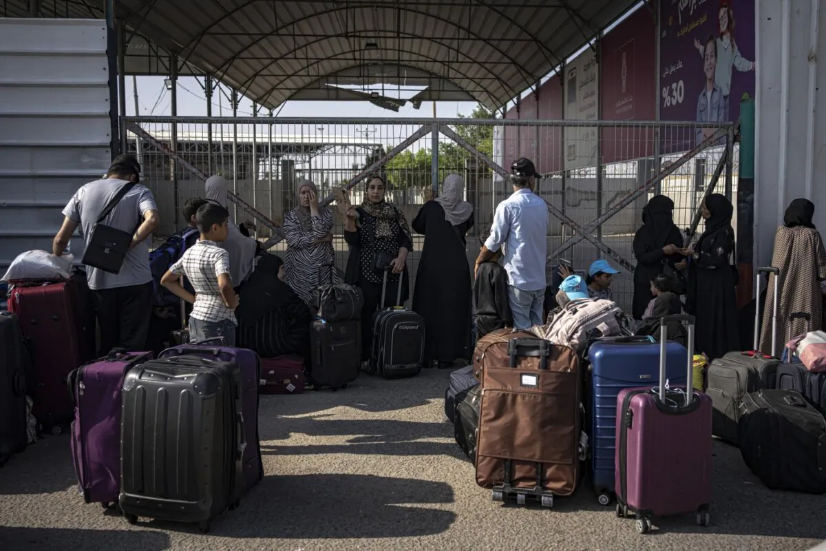 Palestinians wait to cross into Egypt at Rafah, Gaza Strip, on  Nov. 1, 2023. (The Canadian Press/AP/Fatima Shbair)