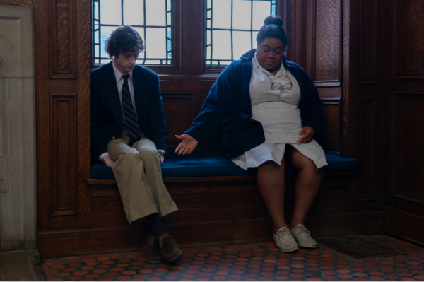 boy and woman sit on a bench in THE HOLDOVERS