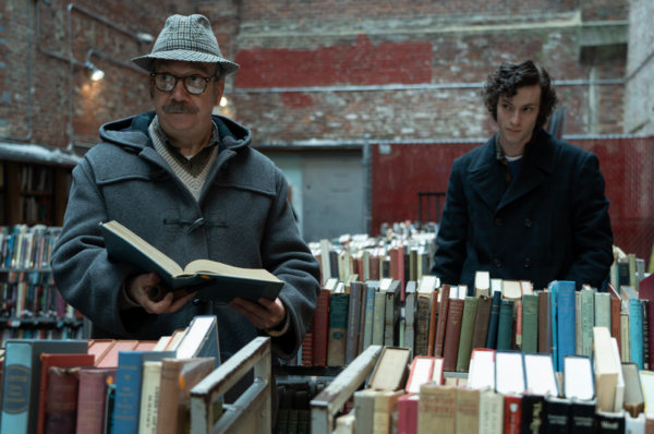 man and boy in a bookstore in THE HOLDOVERS