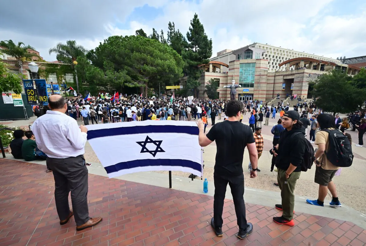Two men display a flag of Israel as students participate in a "Walkout to fight Genocide and Free Palestine" at Bruin Plaza at the University of California in Los Angeles on Oct. 25, 2023. (Frederic J. Brown/AFP via Getty Images)