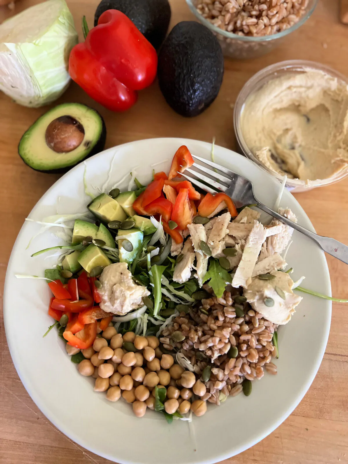 This menopause-friendly Protein Power Bowl pairs protein- and fiber-rich farro with low-fat roasted chicken, avocado, and lemon hummus.  (Gretchen McKay/Pittsburgh Post-Gazette/TNS)