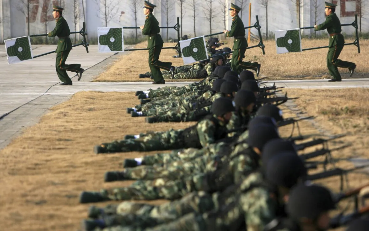 Chinese armed police officers practice their shooting skills as part of an anti-terror drill by the Shanghai Armed Police Corps in Shanghai, China, on Jan. 9, 2007. (China Photos/Getty Images)