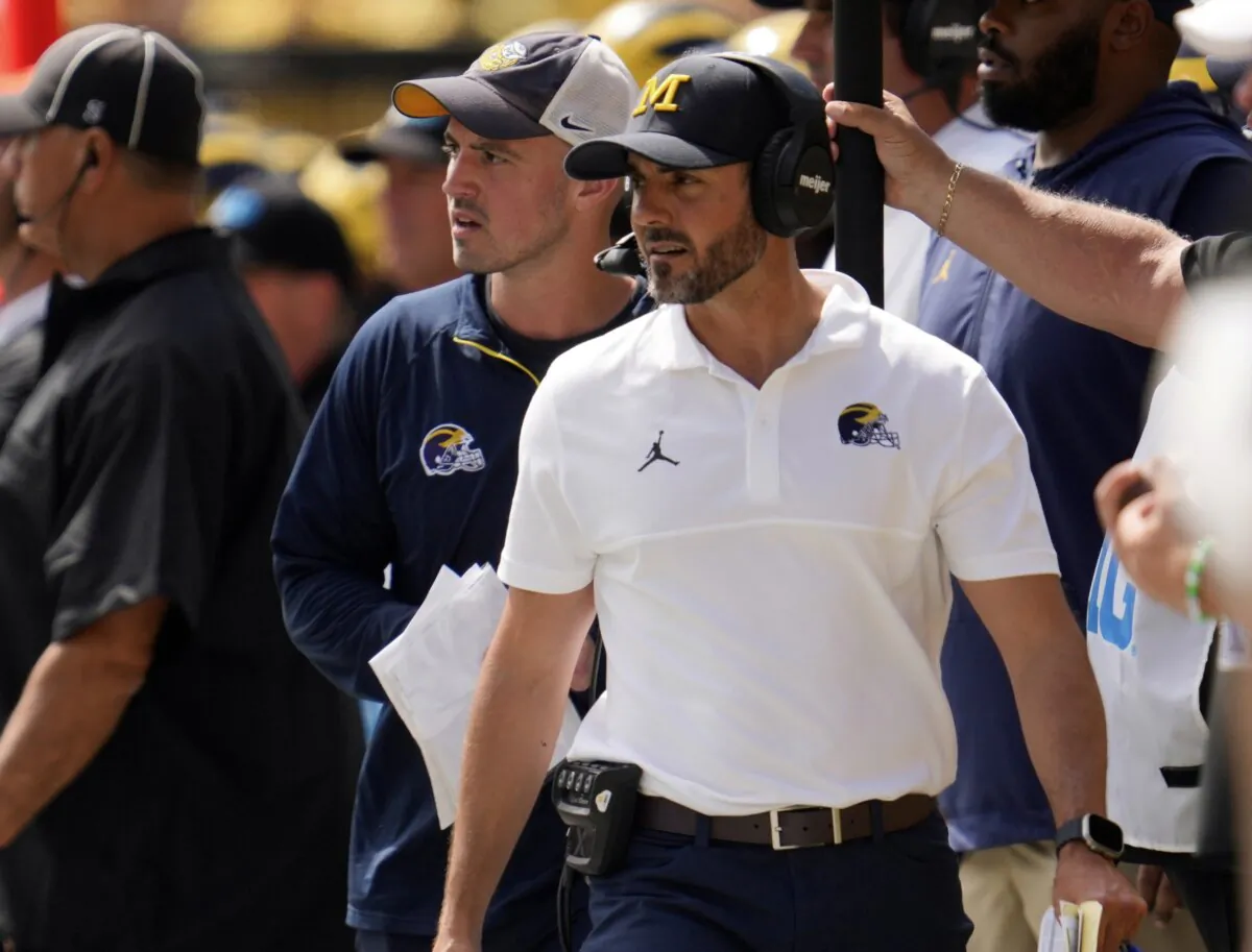 Michigan analytics assistant Connor Stalions (L) looks on as defensive coordinator Jesse Minter (R) watches against East Carolina during an NCAA college football game in Ann Arbor, Mich., Sept. 2, 2023.(Paul Sancya/AP Photo)