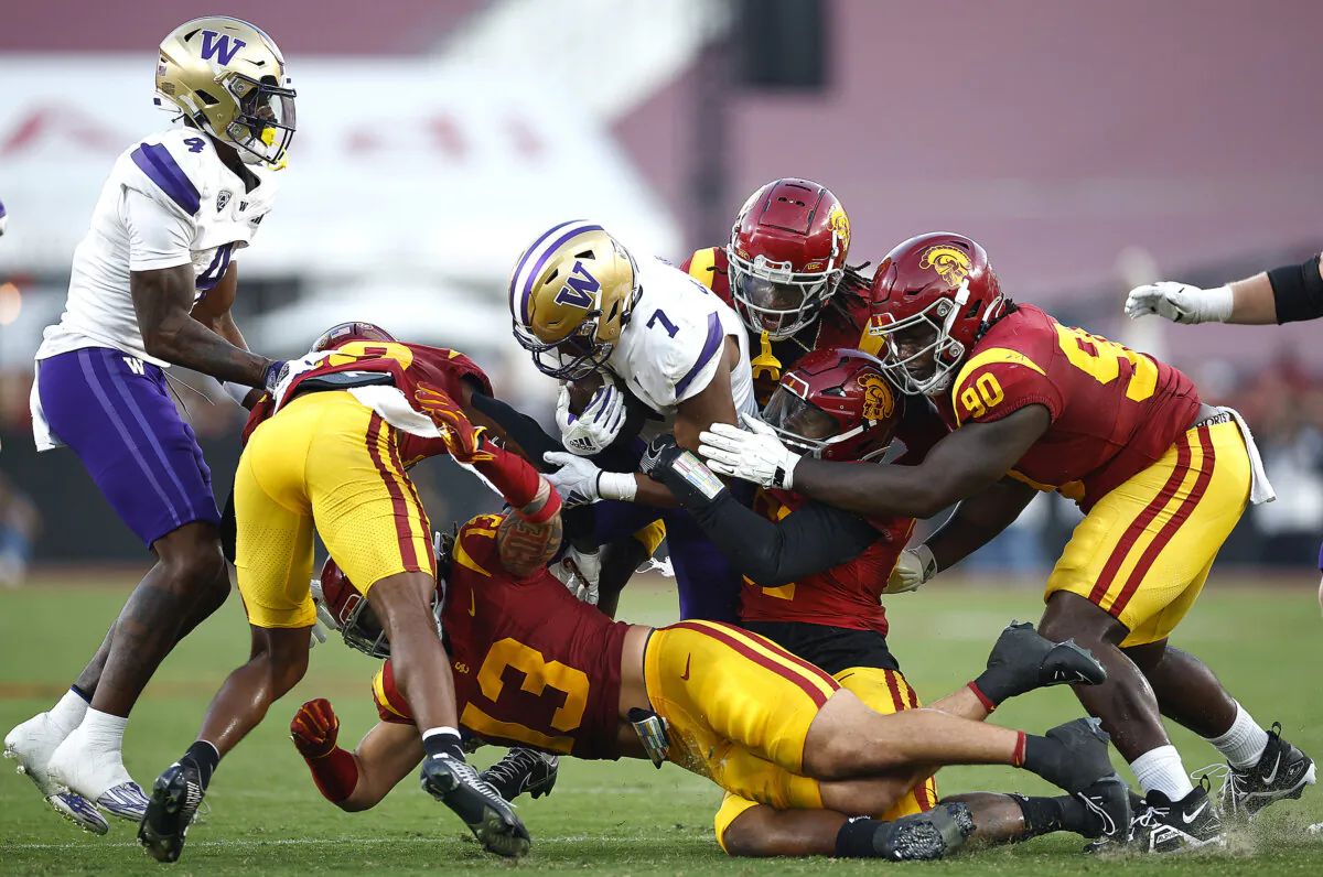 Dillon Johnson (7) of the Washington Huskies runs against the USC Trojans in the second quarter at the Los Angeles Memorial Coliseum in Los Angeles on Nov. 4, 2023. (Ronald Martinez/Getty Images)