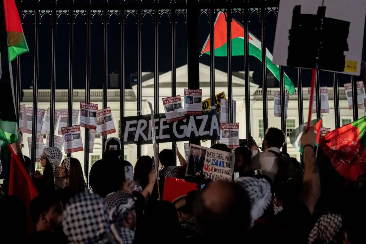 Demonstrators display signs on the White House fence during a pro-Palestinian rally in Washington, on Nov. 4, 2023. (Stefani Reynolds/AFP via Getty Images)
