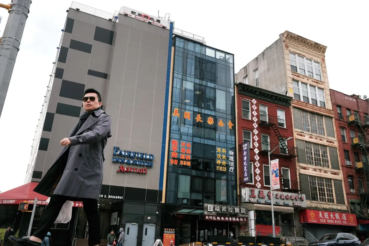 People walk by a building (center) that is suspected of being used as a secret police station in Chinatown for the purpose of repressing dissidents living in the United States on behalf of the Chinese Communist Party stands in lower Manhattan on April 18, 2023. (Spencer Platt/Getty Images)