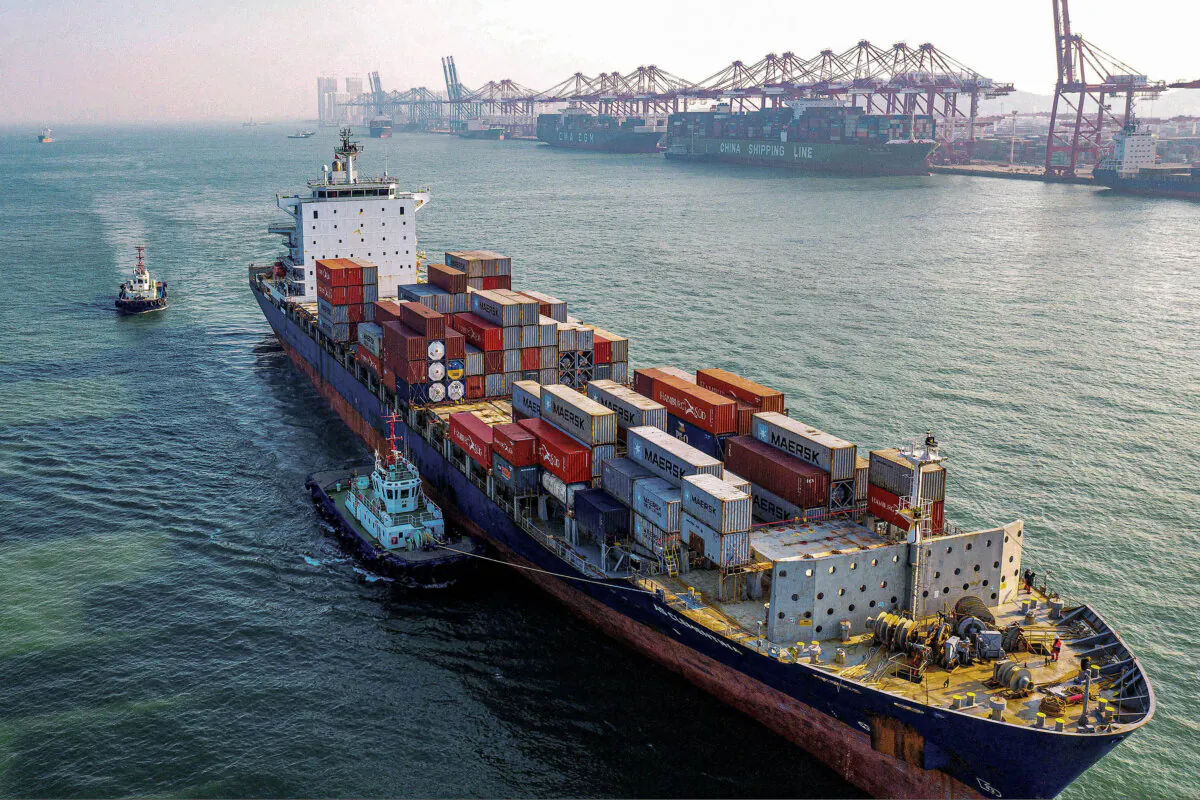 A cargo ship loaded with containers makes its way at a port in Qingdao, Shandong Province, China, on Jan. 14, 2020. (STR/AFP via Getty Images)