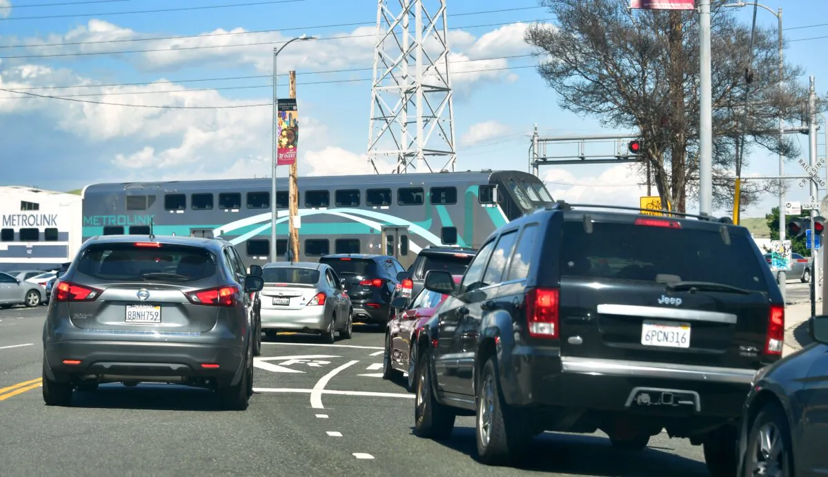 Vehicular traffic comes to a stop as a Metrolink commuter passenger train passes in Los Angeles on April 9, 2019. (Frederic J. Brown/AFP via Getty Images)