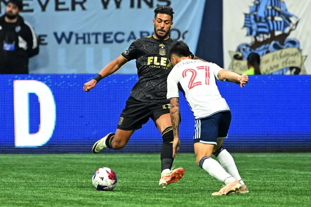 Los Angeles FC forward Denis Bouanga (99) kicks the ball against Vancouver Whitecaps midfielder Ryan Raposo (27) during the second half of game two in a round one match of the 2023 MLS Cup Playoffs in Vancouver, British Columbia, CAN, on Nov. 5, 2023. (Simon Fearn/USA TODAY Sports via Field Level Media)