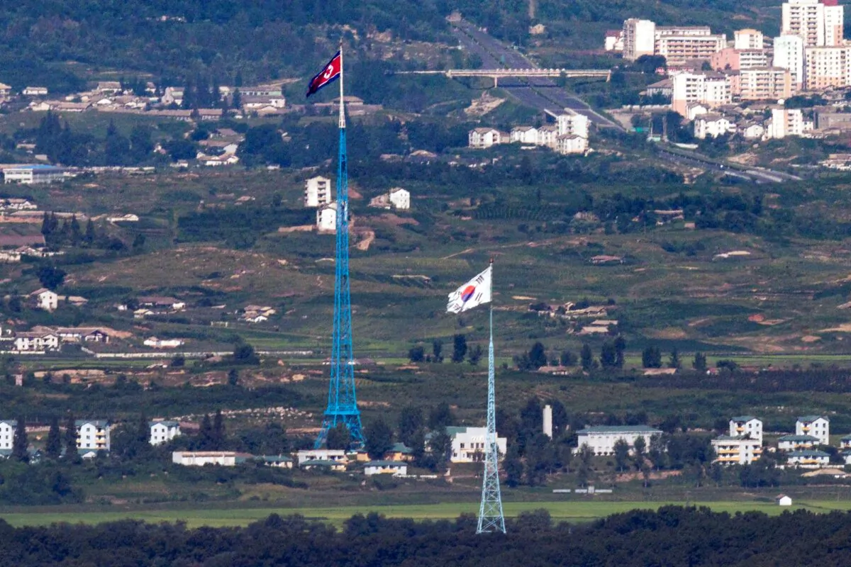 Flags of North Korea, rear, and South Korea, front, flutter in the wind as pictured from the border area between two Koreas in Paju, South Korea, on Aug. 9, 2021. (Im Byung-shik/Yonhap via AP, File)