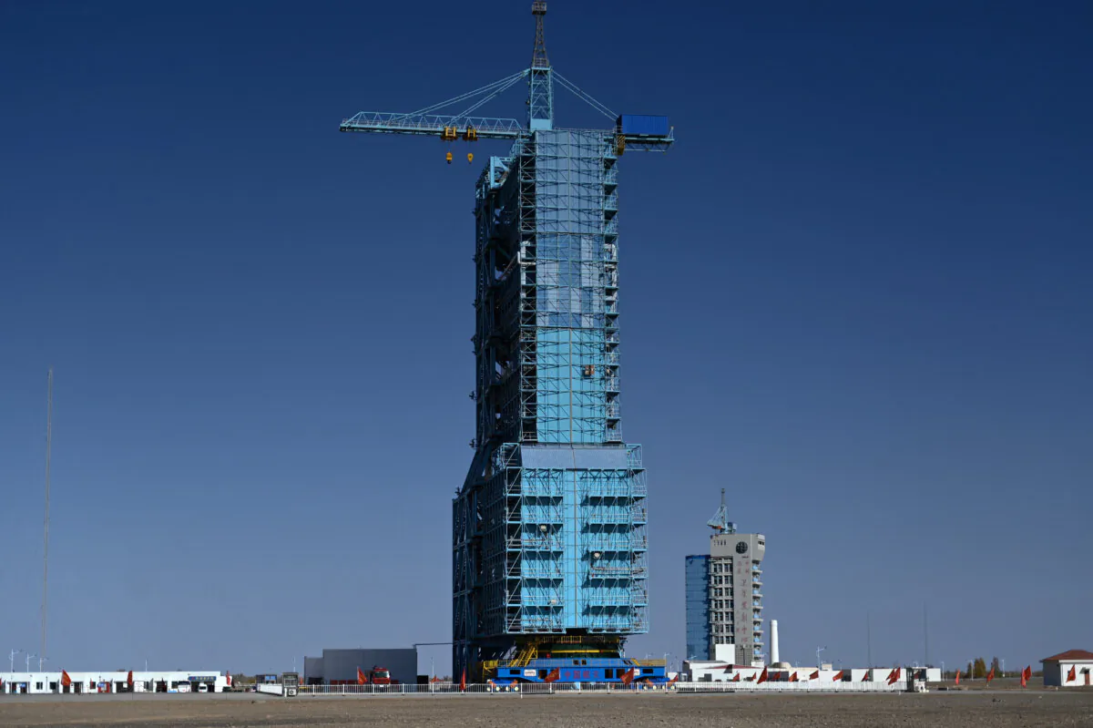 A Long March-2F carrier rocket, carrying the Shenzhou-17 spacecraft, on the launch pad encased in a shield at the Jiuquan Satellite Launch Center in the Gobi desert in northwest China on Oct. 25, 2023. (Pedro Pardo/AFP via Getty Images)