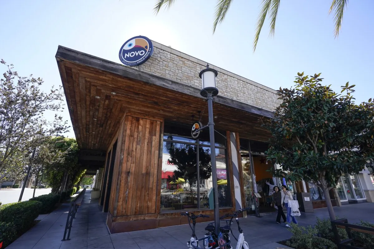 People pass the NOVO Brazil brewery and restaurant in Chula Vista, Calif., on Oct. 31, 2023. (Gregory Bull/AP Photo)