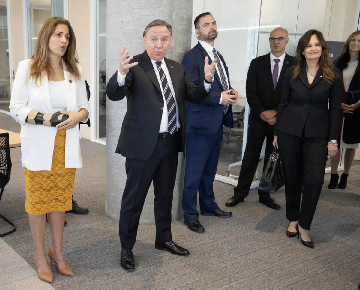 Quebec Premier François Legault is flanked by Higher Education Minister Pascale Déry (L) and HEC chair Helene Desmarais while touring the new building for the HEC business school in Montreal on Sept. 15, 2023. (The Canadian Press/Ryan Remiorz)