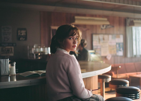 girl sits at counter in PRISCILLA