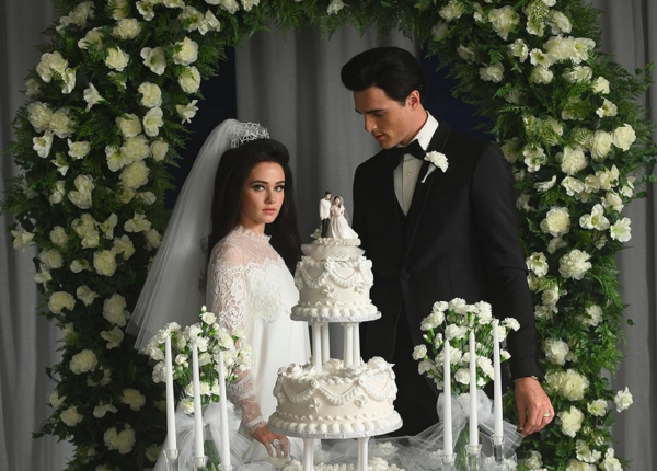 newlyweds with cake in PRISCILLA