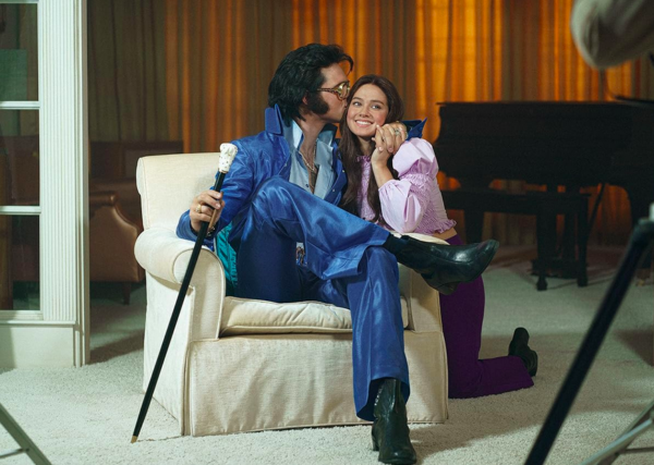 man in blue costume with cane and woman in pink in PRISCILLA