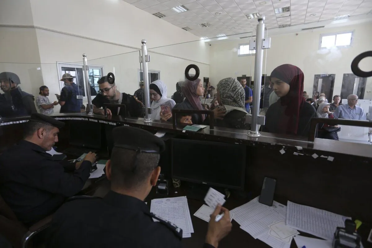 Palestinians with dual nationality register to cross to Egypt on the Gaza Strip side of the border crossing in Rafah on Nov. 2, 2023. (The Canadian Press/AP-Hatem Ali)
