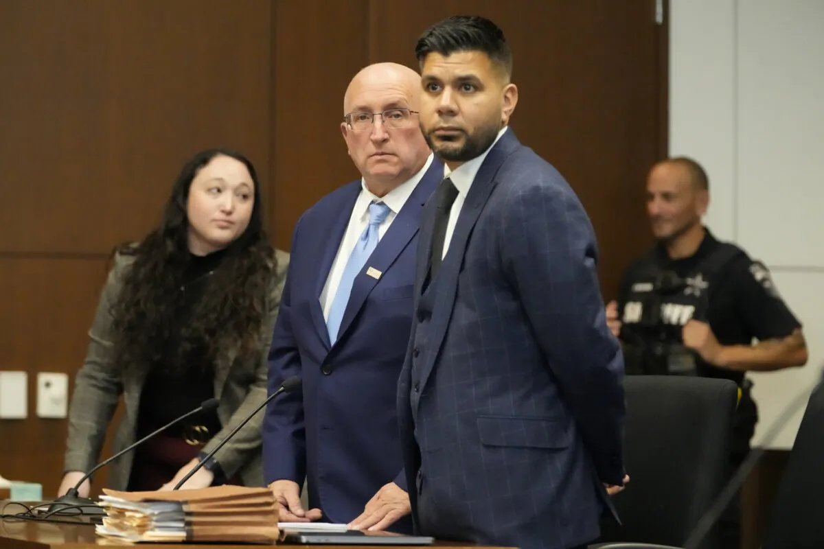 Robert E. Crimo Jr. talks to his attorney George Gomez as he appears before Judge George D. Strickland at the Lake County Courthouse, in Waukegan, Ill., on Nov. 6, 2023. (Nam Y. Huh/Pool via AP Photo)