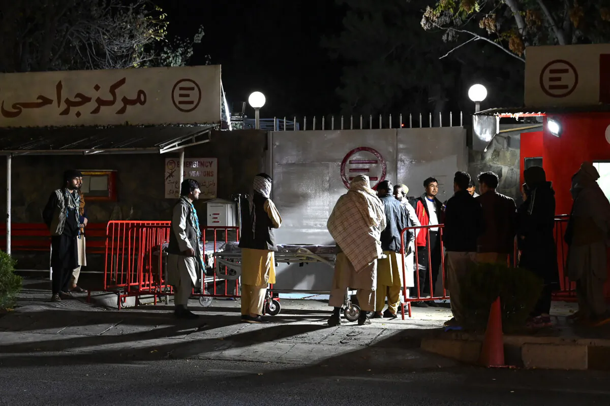 Relatives of blast victims gather outside the Italian aid organisation 'Emergency' hospital in Kabul on Nov. 7, 2023, following an explosion on a bus. (Wakil Kohsar/AFP via Getty Images)