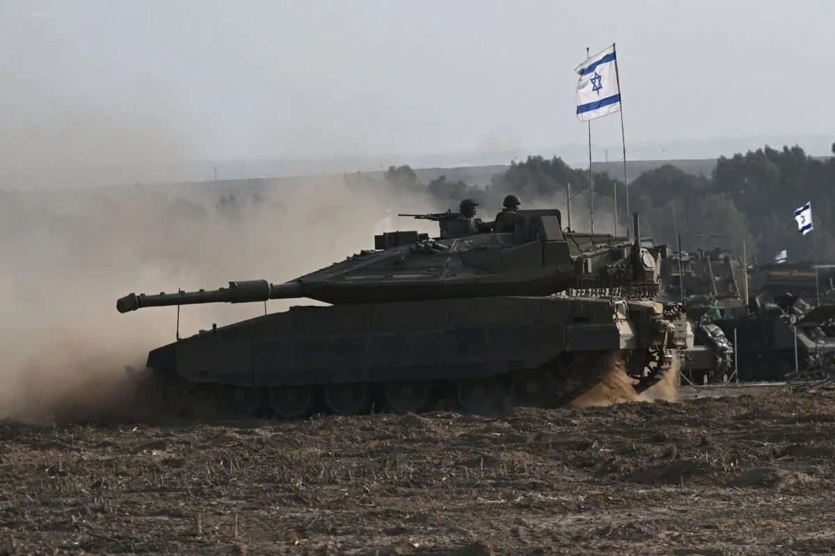 An Israeli Merkava tank is deployed with other armored vehicles along Israel's border with Gaza on Oct. 24, 2023. (Aris Messinis/AFP via Getty Images)