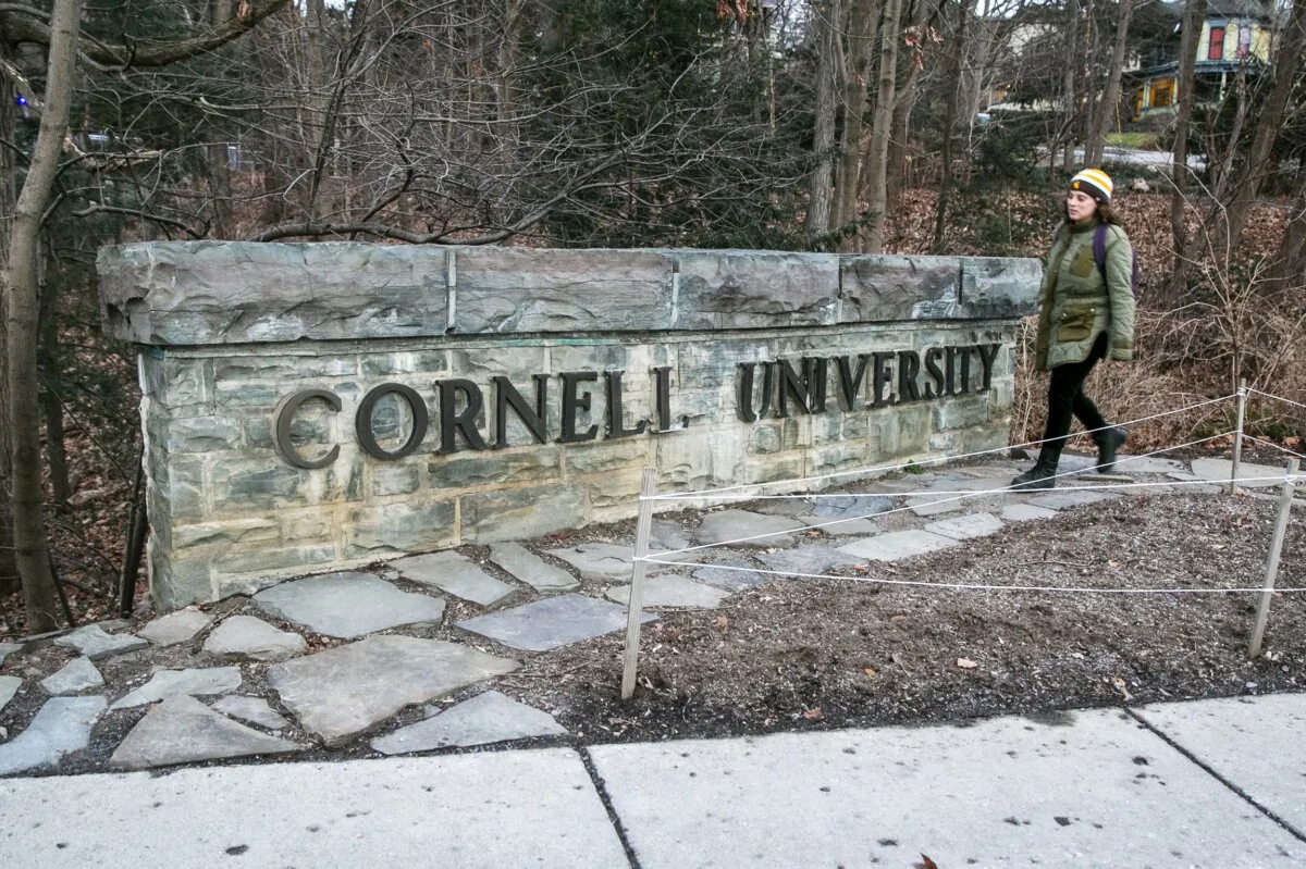 A woman walks by a Cornell University sign on the Ivy League school's campus in Ithaca, N.Y., on Jan. 14, 2022. (Ted Shaffrey /AP Photo)