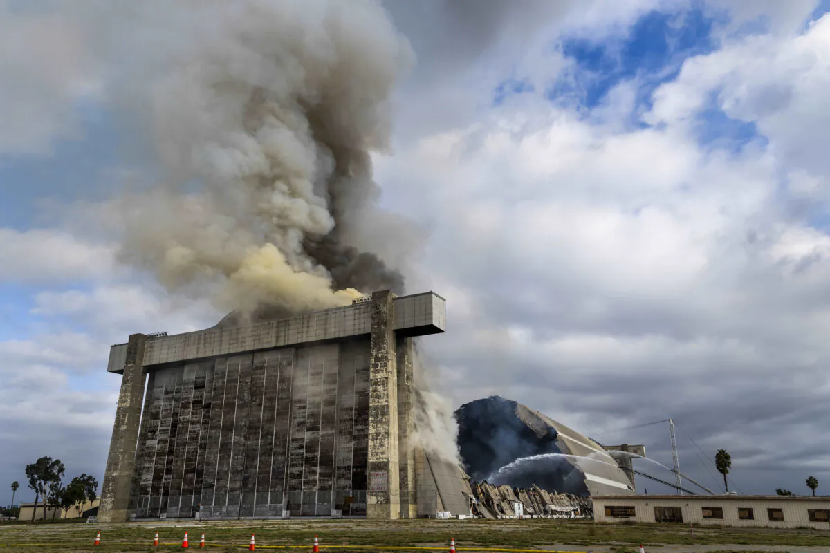 Orange County firefighters battle a fire affecting the north hangar at the Tustin Air Base in Tustin, Calif. on Nov. 7, 2023. (Paul Bersebach/The Orange County Register via AP)