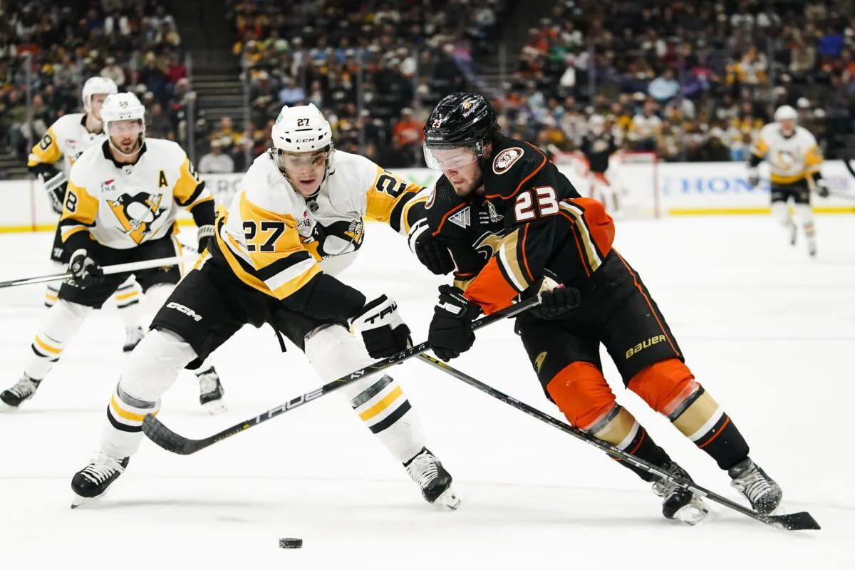 Anaheim Ducks center Mason McTavish (R) and Pittsburgh Penguins defenseman Ryan Graves vie for the puck during the first period of an NHL hockey game in Anaheim, Calif., on Nov. 7, 2023. (Ryan Sun/AP Photo)