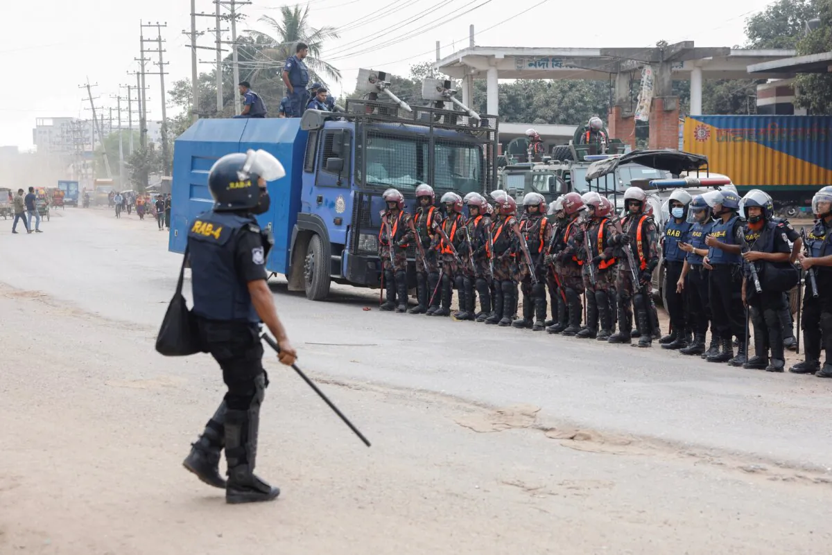 Security forces remain vigilant in front of the garment factories, following clashes between garment industry workers and police over pay, at the Ashulia area, outskirts of Dhaka, Bangladesh, on Nov. 8, 2023. (Mohammad Ponir Hossain/Reuters)