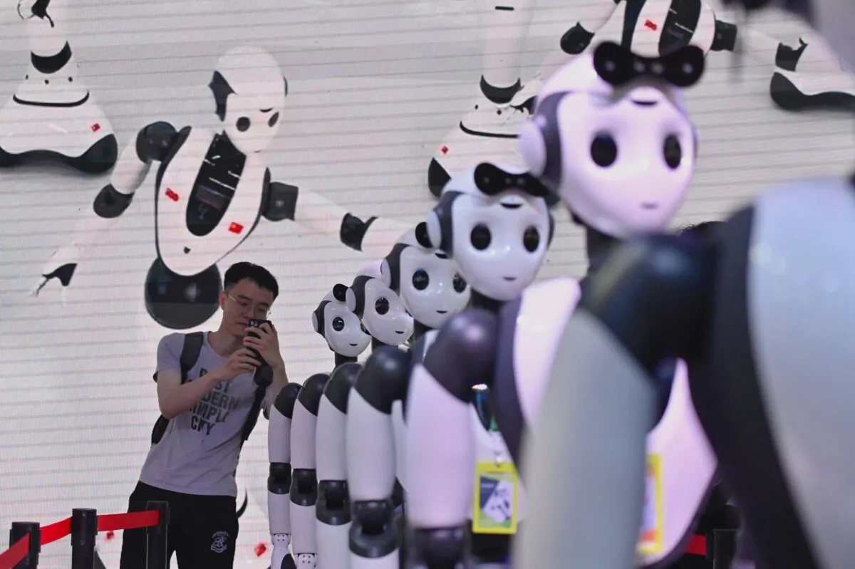 A man takes a picture of robots during the World Artificial Intelligence Conference (WAIC) in Shanghai, China, on July 7, 2023. (Wang Zhao/AFP via Getty Images)