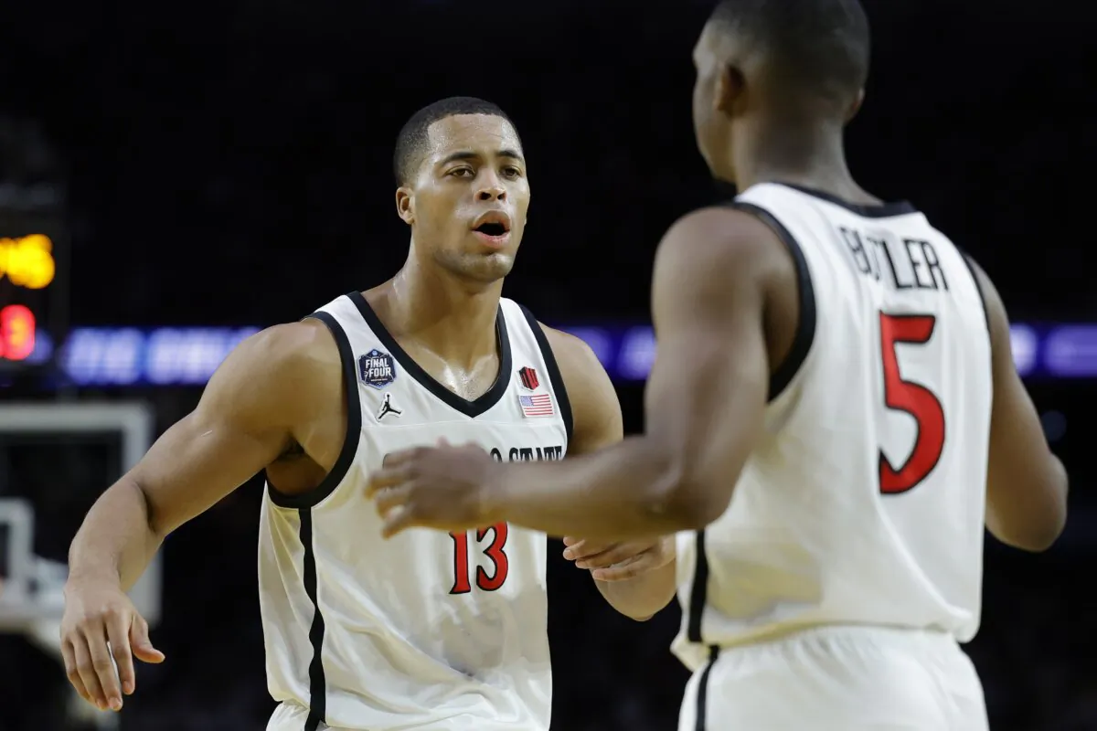 Jaedon LeDee (13) and Lamont Butler (5) of the San Diego State Aztecs react during the second half against the Florida Atlantic Owls during the NCAA Men's Basketball Tournament Final Four semifinal game in Houston on April 1, 2023. (Carmen Mandato/Getty Images)