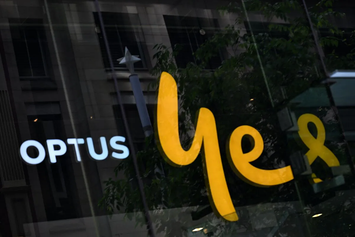 Optus' "Yes" sign reflects in its outlet window in Sydney, Australia, on Nov. 8, 2023. (Saeed Khan/AFP via Getty Images)