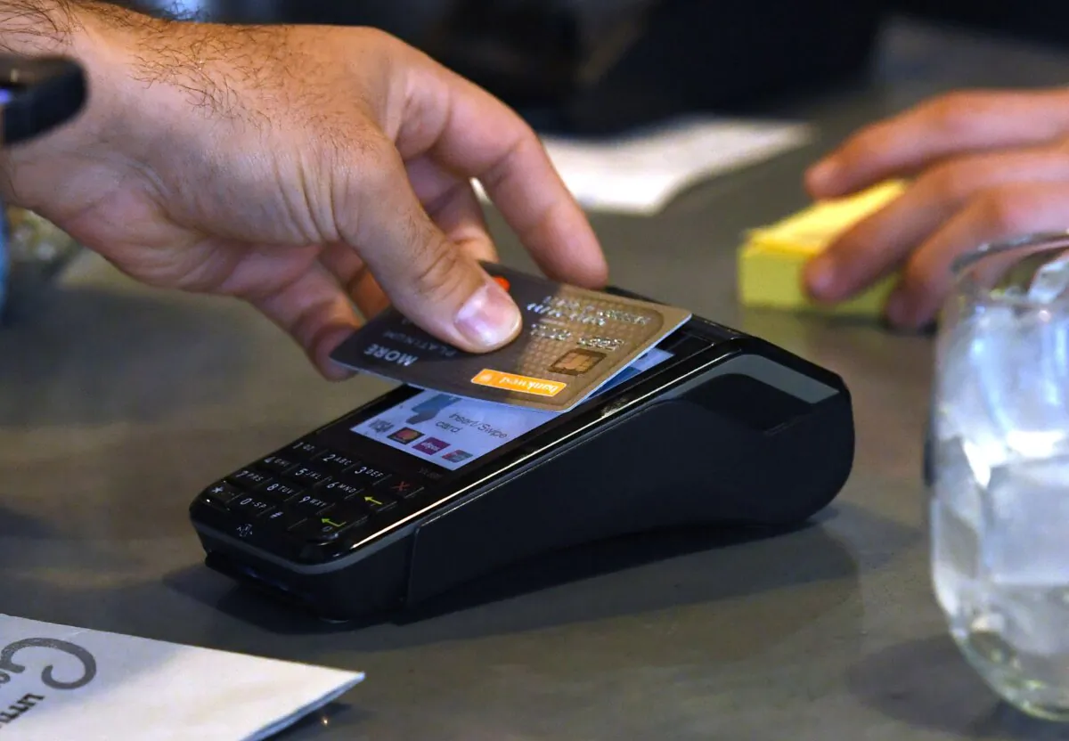 A stock image showing credit card payment at a cafe in Brisbane, Australia, on May 15, 2019. (AAP Image/Dan Peled)