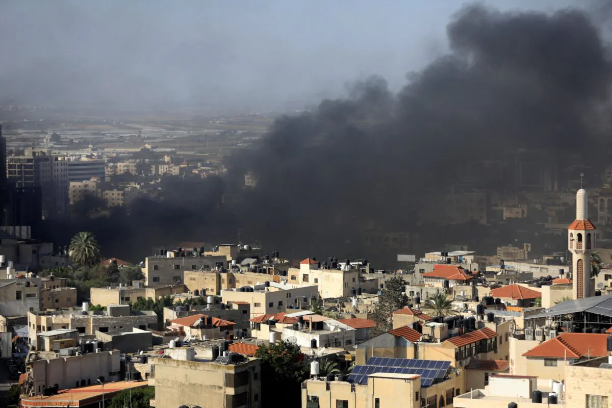 Black smoke rises from the Jenin Palestinian refugee camp during clashes with the Israeli military in the Israeli-controlled West Bank on Nov. 9, 2023. (Zain Jaafar/AFP via Getty Images)