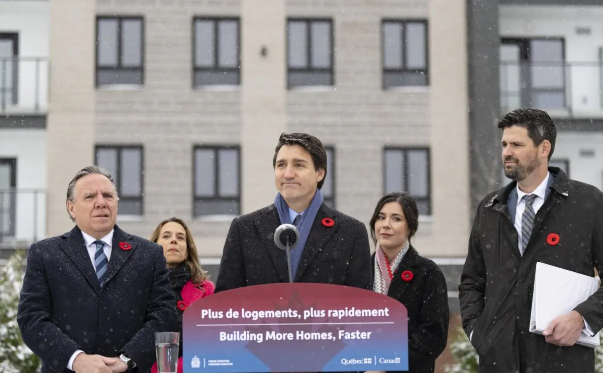 Prime Minister Justin Trudeau (C) makes a housing announcement with Quebec Premier Francois Legault (L) in Longueuil, Que., on Nov. 9, 2023. (The Canadian Press/Christinne Muschi)