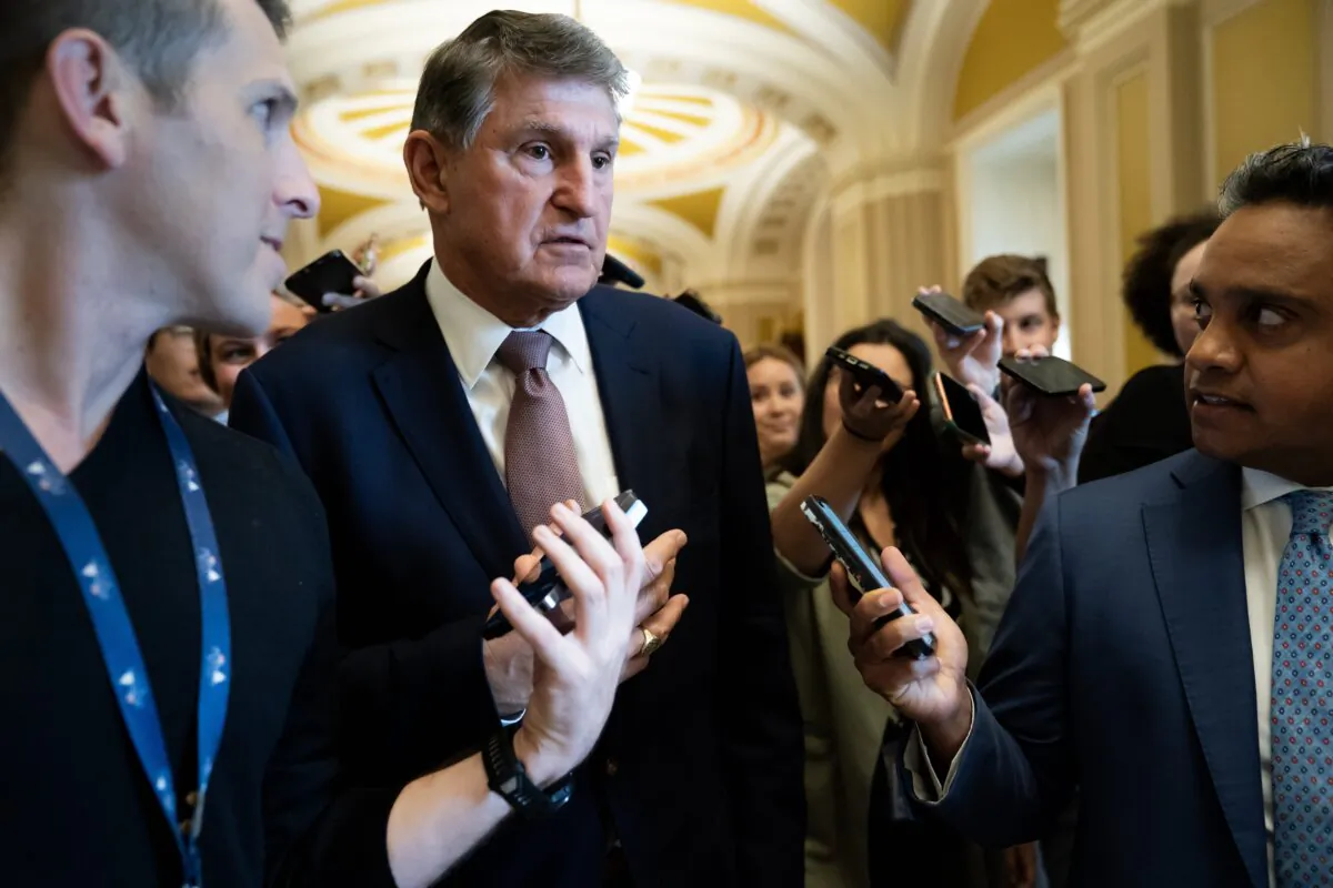 Sen. Joe Manchin (D-W.Va.) speaks to members of the media outside the Senate Chamber in Washington on Sept. 30, 2023. (Nathan Howard/Getty Images)