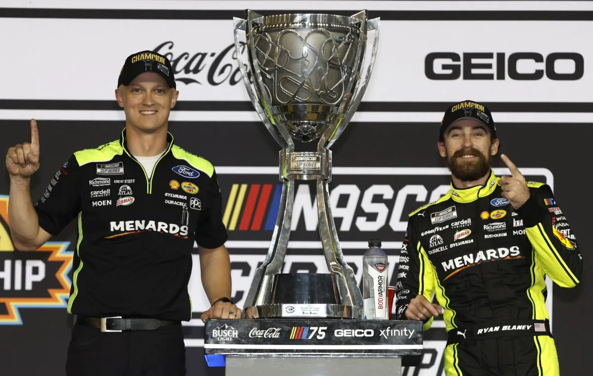 Ryan Blaney, driver of the (12) Menards/Dutch Boy Ford, and crew chief Jonathan Hassler celebrate in victory lane after winning the 2023 NASCAR Cup Series Championship, finishing first of the Championship 4 drivers in the NASCAR Cup Series Championship race at Phoenix Raceway in Avondale, Ariz., on Nov. 5, 2023. (Sean Gardner/Getty Images)